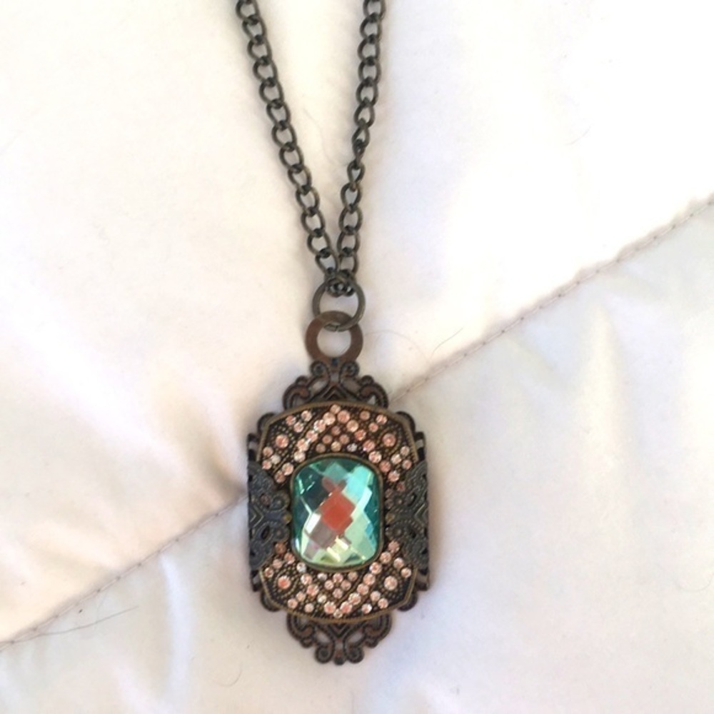 Aquamarine stone necklace encased in a brass‎ setting
